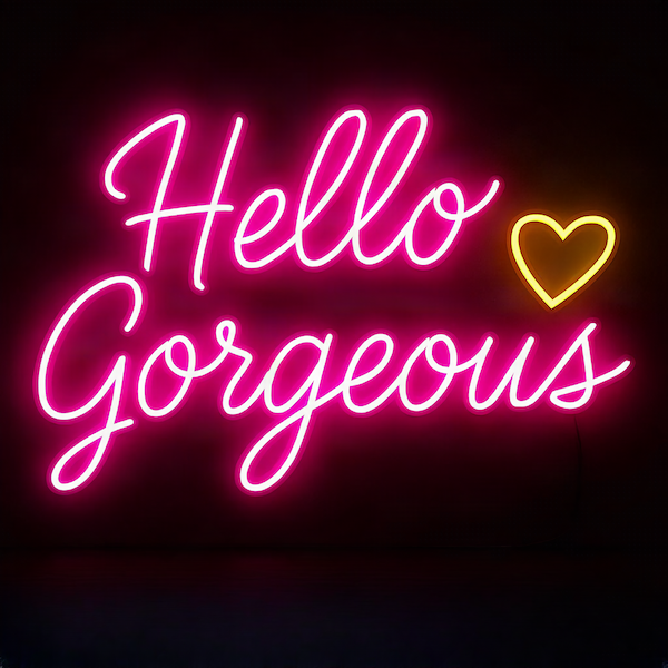 Hello Gorgeous magnet with glowing neon pink script typography and gold heart accent on deep dark background